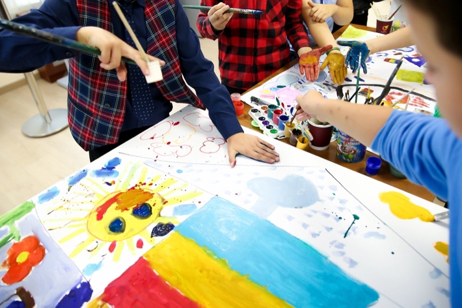 Children painting together in an art activity
