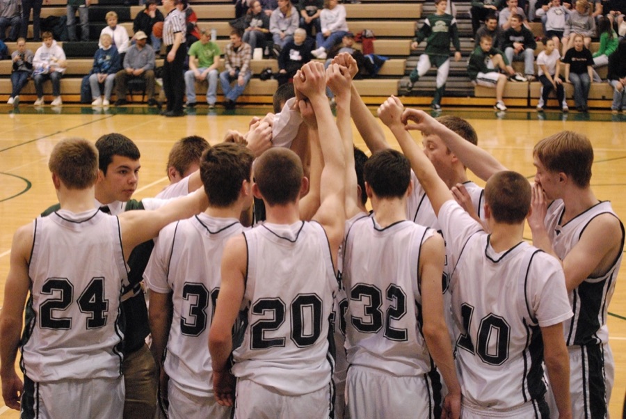 A team of teenagers in a sports huddle